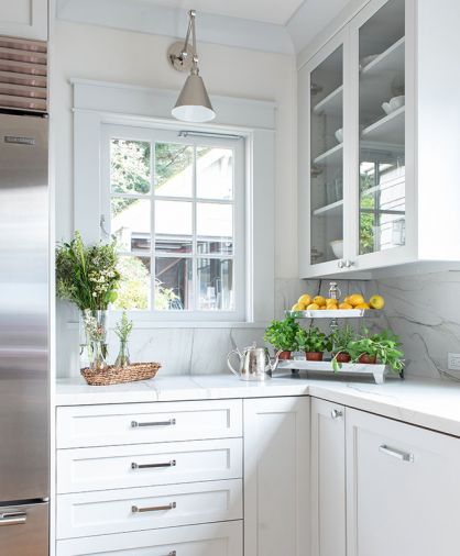 Drawers of various depths and a corner cabinet with a swing out interior provide essential and flexible storage in the kitchen.