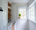 Deep cabinets and pullout bins were added to the laundry.