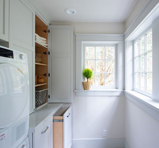 Deep cabinets and pullout bins were added to the laundry.