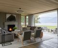 Bifold LaCantina doors open onto terrace overlooking Lake Chelan. Custom Lee Industries sofas by M Design + Interiors.