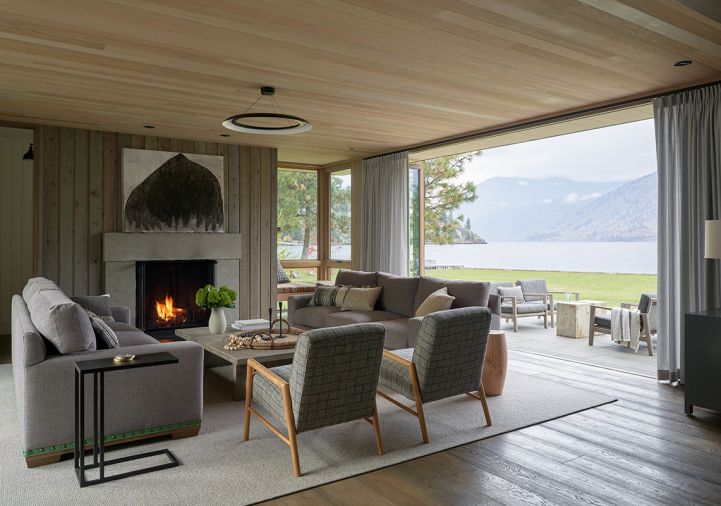 Bifold LaCantina doors open onto terrace overlooking Lake Chelan. Custom Lee Industries sofas by M Design + Interiors.