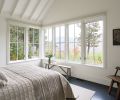 Simplicity reigns in the master bedroom, making the view out to the lake the focal point. Echoing the kitchen, the master features a vaulted ceiling with ceiling rafters that add a sense of airiness.