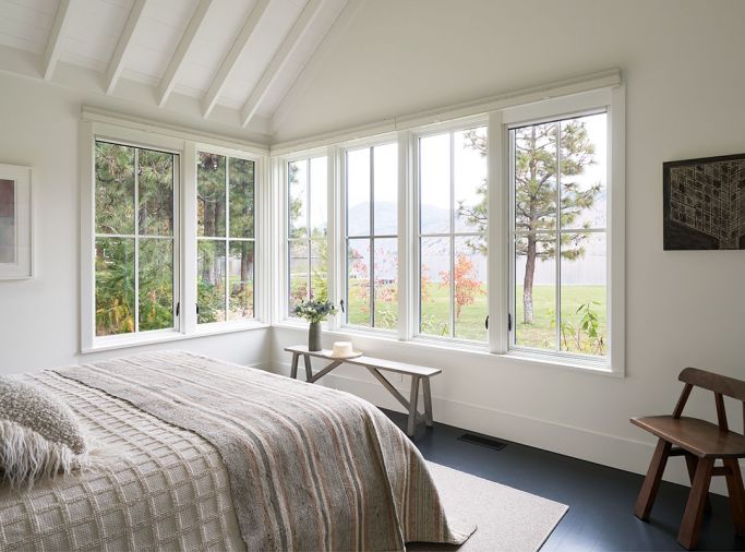Simplicity reigns in the master bedroom, making the view out to the lake the focal point. Echoing the kitchen, the master features a vaulted ceiling with ceiling rafters that add a sense of airiness.