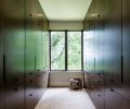 To maintain visual flow from room-to-room, warm Douglas fir wood with custom stain was used on the newly crafted master closet, with hanging space above and drawers below – for a tidier, clutter-free look.