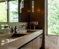 The medicine cabinet is sleekly hidden behind the wood paneled wall at right. Gessi Rettangolo wall mounted faucets add panache.