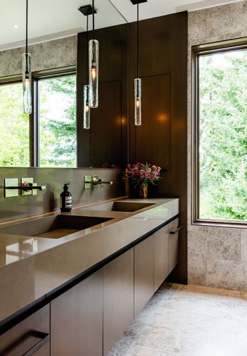 The medicine cabinet is sleekly hidden behind the wood paneled wall at right. Gessi Rettangolo wall mounted faucets add panache.