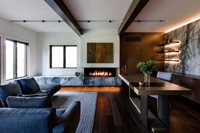 What began as a custom Mayer Design dining table was transformed into a combination wood and metal desk made to fit the office space. LED lit wall-mounted shelves that appear to be free-floating feature integrated hardware between shelves for a cleaner look against spectacular Invisible Blue marble. Inform Flex Form sofa, area rug by Driscoll Robbins.