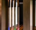 Patterson worked with artist Steve Hirt to design the custom art glass and metal room divider whose lower portion not only lights up, but also changes color.