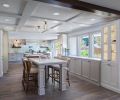 A rustic ceramic subway tile reaches from the countertop to the ceiling and echoes the tones used in both the revamped kitchen and casual eating area. Counters throughout are Cambria Torquay quartz. One window grew to a larger window and French doors to allow access to the large backyard and to let the light stream in. The couple, who are not fans of upper cabinets, limited their use to one corner, which provides a coffee station.