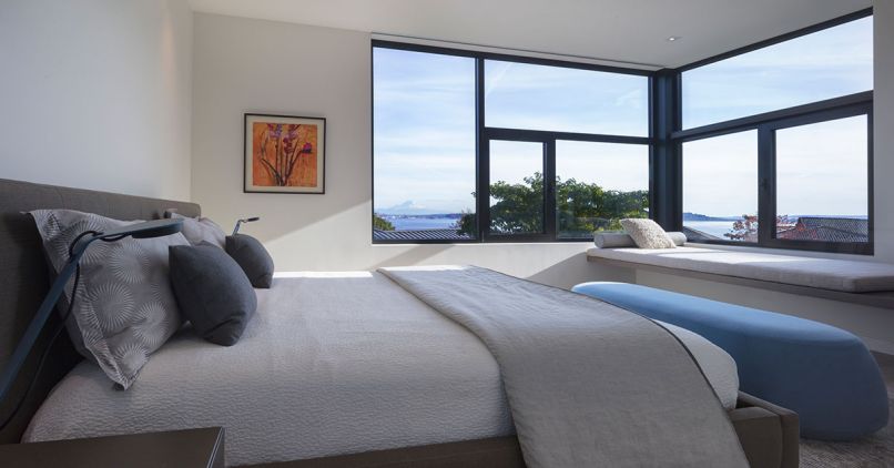 Minimally designed master bedroom features Bensen bench.