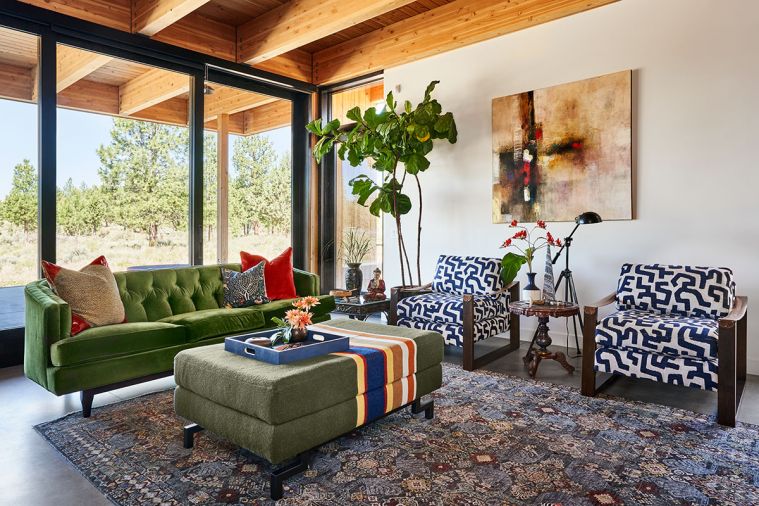 Velvet green Rejuvenation sofa became a color anchor for Todd’s design. Another Pendleton National Park blanket upholsters her unique ottoman with custom metal legs. A blue Feizy rug grounds it. Bali side table adds flair to Todd’s redesigned Massoud chairs. Triadic color scheme echoes red from artwork.