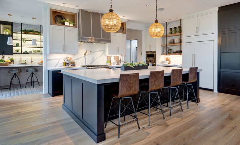 he kitchen, conveniently located off the main living area, features a custom range hood with metal strappings, Wolf range, steam oven, convection oven, 48' Sub-Zero refrigerator, Quoizel pendants, and Four Hands Diaw bar stools in Havana. 
Photograph © Jesse Prentice