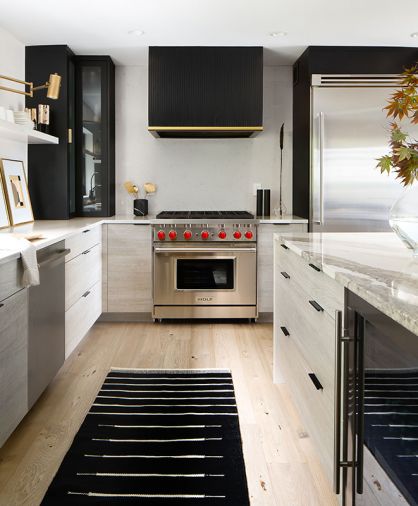 After being taken down to a shell, the kitchen was refitted and refreshed in a modern black-and-white design. Copious storage is available in the custom Bellmont cabinetry and island. The space is divided so that the chef’s zone holds all appliances, plumbing, and counter and serving spaces in a diamond-shaped arrangement; while stools from Restoration Hardware provide visiting and an informal eating area in another area. The separate but connected spaces ensure conversation between everyone in the kitchen.