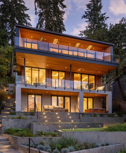 Architects teamed with Riverland Homes to replace an oft-remodeled 1930s home with modern Pacific Northwest design with unobstructed views of Oswego Lake. The team dug into steep hillside to accommodate stacked design. Truncated patio was replaced by a multi-layered landscape by Laura Canfield.