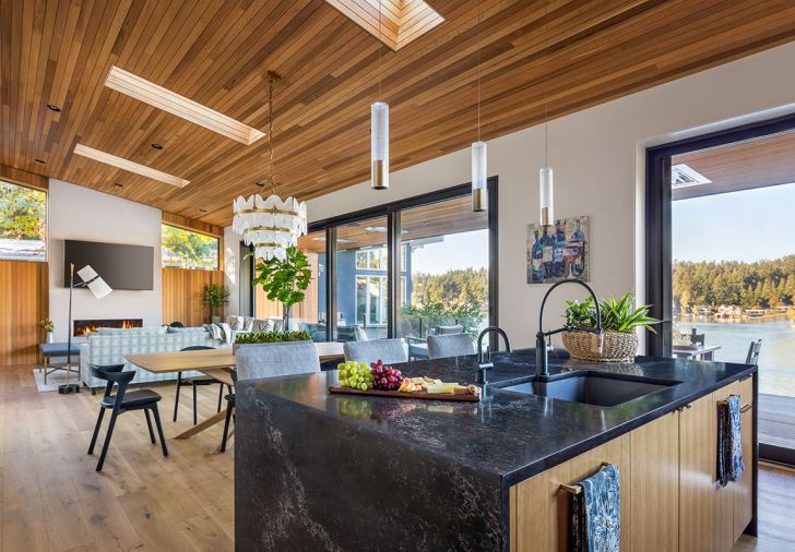 Kitchen island Vanilla Noir Polished Caesarstone. Kolbe windows from Portland Millwork and 30' Weiland lift and slide door opens onto view. Coulee Concrete stucco over plaster.