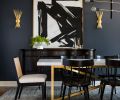 Dramatic dining room transformation includes bold artwork from J Garner Home set against Cyberspace Sherwin Williams walls and Visual Comfort Lighting gilt gold sconces. Dining room showcases gilt gold Visual Comfort sconces. and matte black and brass Hudson Valley Lighting chandelier. Four Hands J Garner Home chairs pair with Restoration Hardware table.