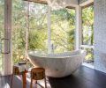 Nestled in the master bath between shower and double vanity is the custom carved 1200 lb. imported tub. Ann Sacks floor tile. EQLight Cloud Pendant.