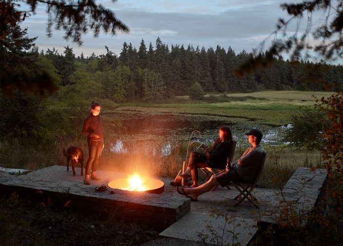 The firepit at the edge of the meadow overlooks the pond and is a natural place for family to gather