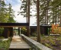 A Western Red Cedar path leads to the entry, bordered by a stacked local Basalt stone wall.