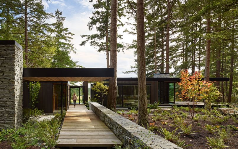 A Western Red Cedar path leads to the entry, bordered by a stacked local Basalt stone wall.