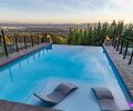 POOL Stamped concrete – not pavers - border the infinity pool built into the newly designed backyard by GRO Outdoor Living. Cascade Pools created a 9  deep end allowing homeowners to dive freely.