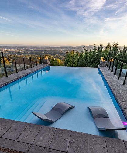 POOL Stamped concrete – not pavers - border the infinity pool built into the newly designed backyard by GRO Outdoor Living. Cascade Pools created a 9' deep end allowing homeowners to dive freely.