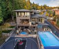 SPORT COURT The Sport Court, separated from pool by topless glass and topped glass railing installed by Rail Pro, was made possible by 13  South retaining wall that wraps around backyard area.