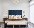 Blue Pasha Home bed frame with Four Hands bedside tables evokes river. Gold backed Visual Comfort crystal sconces pair with CB2 quartz chandelier. Carole Fabrics sheers filter light.