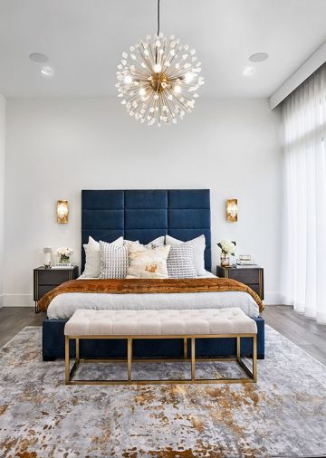 Blue Pasha Home bed frame with Four Hands bedside tables evokes river. Gold backed Visual Comfort crystal sconces pair with CB2 quartz chandelier. Carole Fabrics sheers filter light.