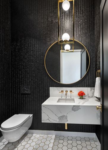 Powder room Calacatta ESD quartz wrapped hanging sink. Winfield Thybony wallpaper adds dramatic backdrop for Four Hands pendant and Elegant Lighting mirror. Brass inlaid flooring.