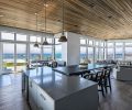 Unobstructed Face Rock views warmed by cedar tongue and groove ceiling grounded by lighter, white oak engineered flooring with tint of blue.