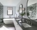 Primary bathroom features Z Collection Symphony (Grigio) tile and Dreamline cabinets with Alno hardware. Teltos quartz countertops in Beige Cloud read grey. Handsome Crosswater London tub.