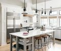 To counter the cool, white, grays and blacks, Gray added wood beyond the flooring, since it’s not at eye level. Wood-topped barstools draw the eye up to the windows and warm bamboo shades.