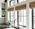 White farmhouse sink pops against surrounding Java Noir quartz countertops. Bronze Waterstone faucet adds warmth to the mix.