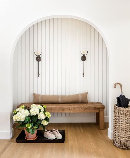 In the entry, an arched alcove is a lovely spot to remove shoes.
