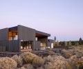 Corey Martin’s experience as a sculptor focused on making form inspired by the landscape contributed to his vision of creating architecture more intrinsically connected to Central Oregon’s unique geological landscape. Rooted in the surroundings of sagebrush below and endless skies above, Hacker Architects carved out this home as one whole from inside out. Dramatically stained Western Red Cedar on the exterior is naturally finished on interiors that extend from courtyard to kitchen. At far right is a small courtyard off the great room. An in-ground spa off the primary bedroom is sheltered by a louvered trellis above.