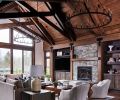 A pair of black iron Pearson chandeliers draw eye to superbly finished beams. Furnishings echo tones of El Dorado Stone fireplace with CR Laine Lincoln chairs in Winchester Vapor Leather and Adriana sectional atop wool Capel rug in Fog.