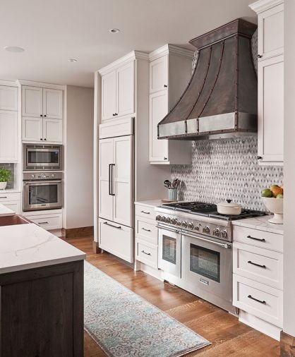Custom Bellmont Cabinets in White/Taupe from 1900 Rustic Hickory, Folkstone line. Luxurious Twill/Blue, hand knotted 100% NZ handspun wool Loloi Rug makes cooking with Thermador appliances dreamy.