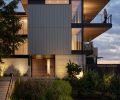 Pivot Cedar gate separates exterior from street. Deep cantilevered cedar eaves and roof provide protection from weather. Native plants, vine maples, dogwood, Oregon grape protect severe slopes.