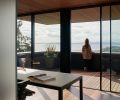 Office with covered sleeping porch. Room & Board custom Parsons desk with white glass faces West.