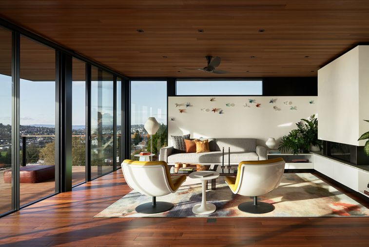 The lounge features B&B Italia Awa table between yellow leather Artifort chairs. Custom Corian and wool sofa beneath Lukeke birds by Jacombe & Rutecki. Nelson Pear Lotus lamps.