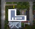 Aerial view of property with photovoltaic solar array.