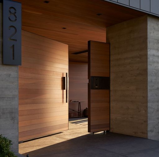 Cedar gate entry leads to a protected limestone entry walk and features c+d’s custom hardware crafted by Dovetail. Access control, buzzer, and video doorbell at right.