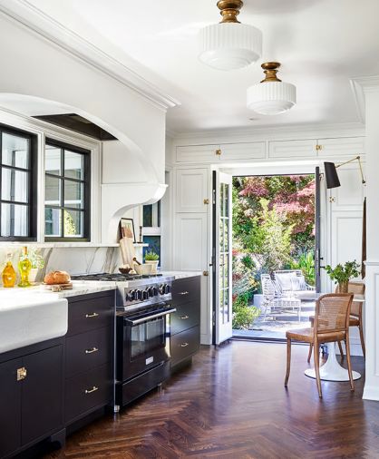 A backyard entry and pantry door occupied the space where the Blue Star range from Eastbank Appliances and a trio of Marvin windows now provide an excellent cooking experience with better light. The dramatic arch disguises top-of-the-line Vent-A-Hood.