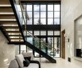 A stunning entrance hall greets visitors to Max and Nadia Rombakh’s Seattle home in the Bridle Trails neighborhood. Tumbled porcelain floors by Dal Tile and Andersen Windows join a custom staircase by Northrup Fabricators.