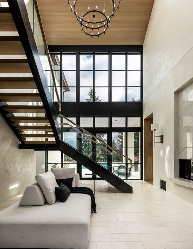 A stunning entrance hall greets visitors to Max and Nadia Rombakh’s Seattle home in the Bridle Trails neighborhood. Tumbled porcelain floors by Dal Tile and Andersen Windows join a custom staircase by Northrup Fabricators.