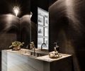 The powder room is covered in York Grasscloth, with a custom sink and vanity fabricated from Pental quartzite.