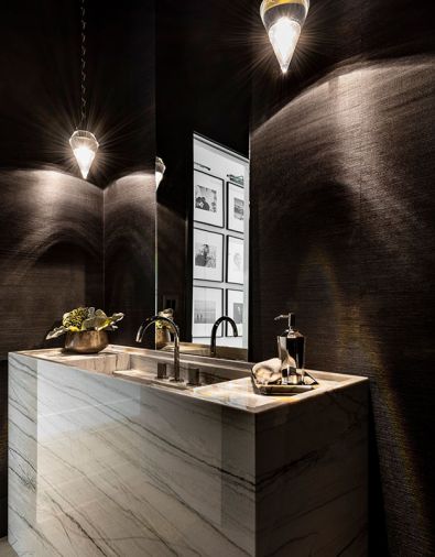 The powder room is covered in York Grasscloth, with a custom sink and vanity fabricated from Pental quartzite.