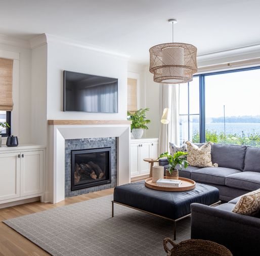 This cozy family room, outfitted with a sectional and ottoman from Lee Industries and DMI rug, is a favorite spot to sit and enjoy the views.