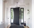 The new entry has a Visual Comfort chandelier and rug from Kush Rugs.